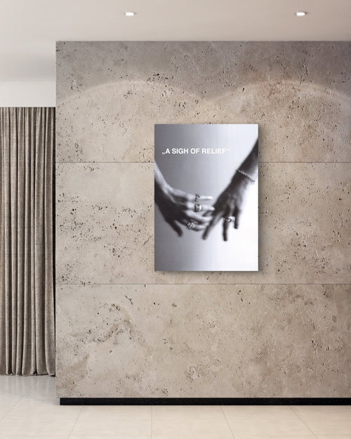 Modern interior with a sculpture and a wall art piece on a textured wall.