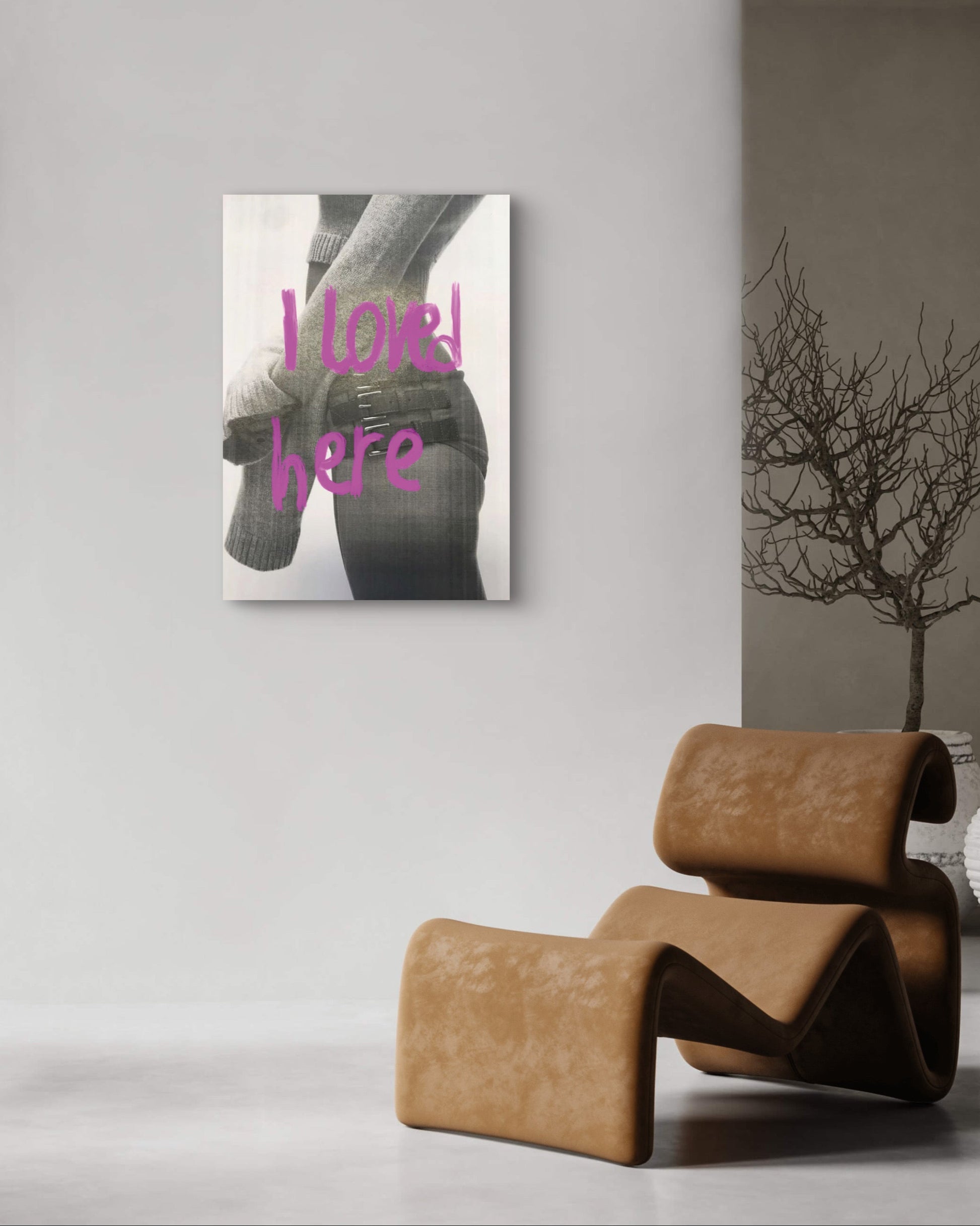 Modern interior with a brown chair, shelves with decor items, and a wall art piece.
